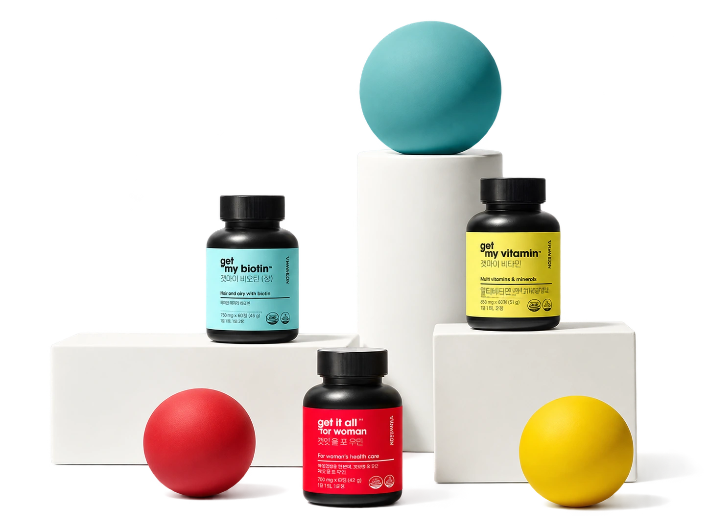 Original black supplement bottles on white plinths with colorful spheres